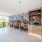 Dog-Friendly Luxury Apartments In Naples, FL - The Peal Founders Square Apartments - Cyber Lounge In A Bright Airy Room With Computers, Chairs, A Printer, And Books
